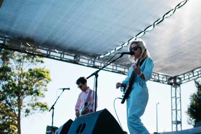 a woman singing with a guitar